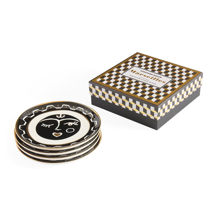 Set of decorative plates with a face design in a checkered box packaging on a white background