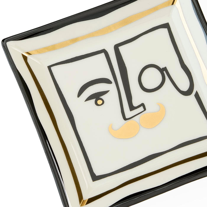 Decorative plate with artistic face design and 'Lou' text on a white background