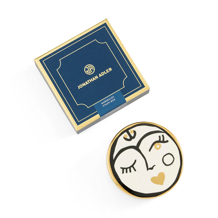 Decorative plate with artistic design and Jonathan Adler packaging on a white background