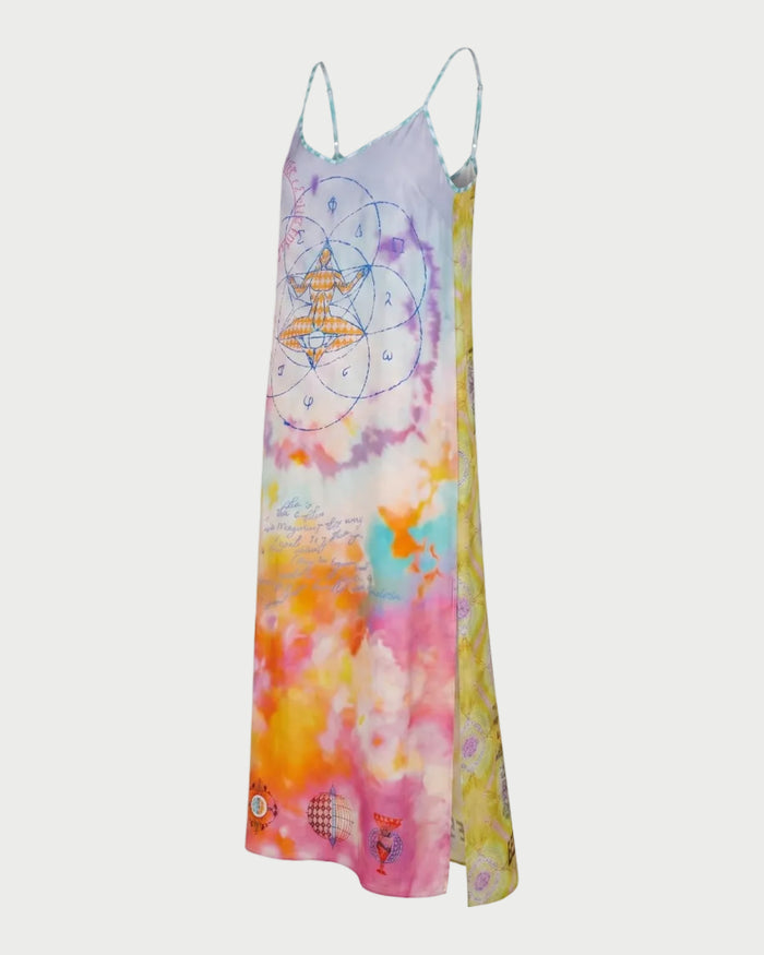 The ME369 Olivia Camisole Dress is a colorful, sleeveless maxi with thin straps, featuring a pastel tie-dye pattern in pink, purple, orange, and yellow, plus abstract and astrological designs on the front.