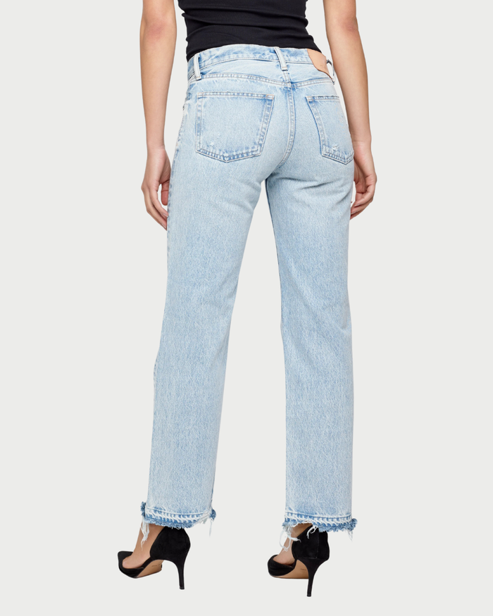 Light blue jeans worn by a person on a white background