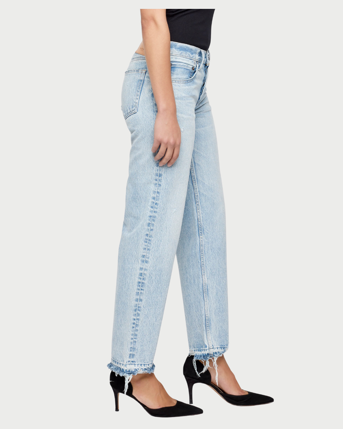 Light blue jeans worn by a person on a white background