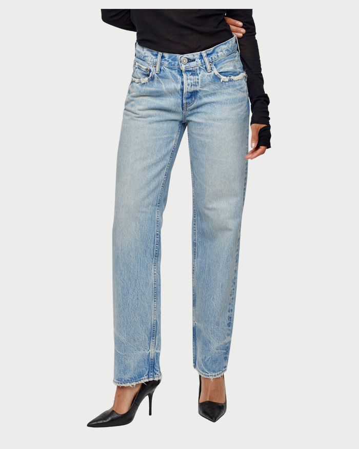 A person wears Moussy Wildwood Straight Leg Jeans in a light wash, paired with black pointed-toe heels and a black long-sleeve top. The photo is cropped at the shoulders.