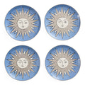 Four round ceramic plates arranged in a 2x2 grid, each featuring a light blue background with a stylized sun face design in white and gray.