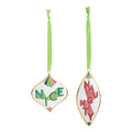 Two decorative hanging ornaments on a white background, each with a light green ribbon loop. One ornament is white with green and pink lettering reading "NYCE," and the other is white with pink lettering reading "NYC" and small green and pink accents.