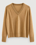 The One Grey Day Sloane Cashmere V-Neck is a camel-colored, long-sleeve sweater featuring ribbed cuffs and hem, crafted in a relaxed fit for effortless elegance and shown against a plain light background.