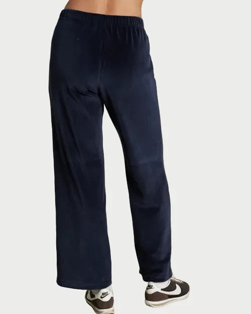 Navy blue sweatpants worn by a person on a plain background