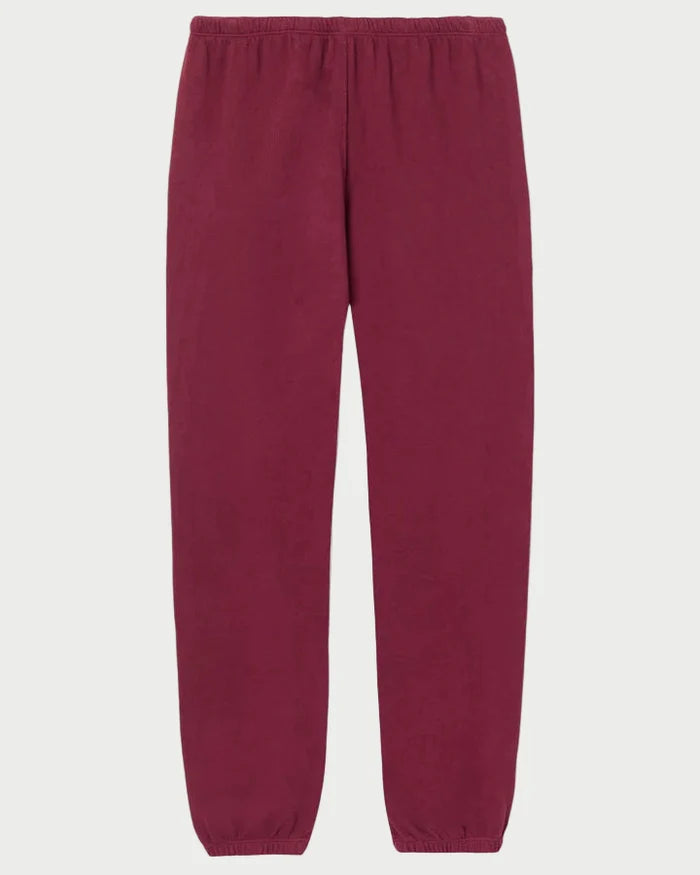 The Perfectwhitetee Johnny Sweatpant in burgundy by perfectwhitetee is made from soft French terry cotton and features an elastic waistband and ankle cuffs, shown against a plain white background.