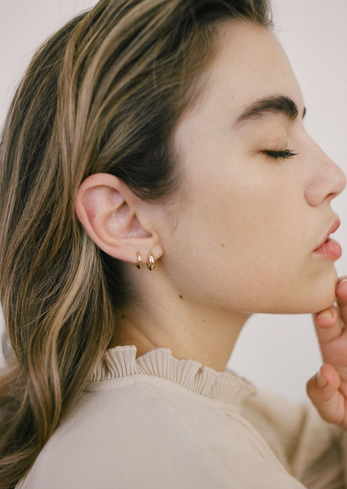alt="Petite Hoop Huggie Earrings with mini hoop huggie earrings"