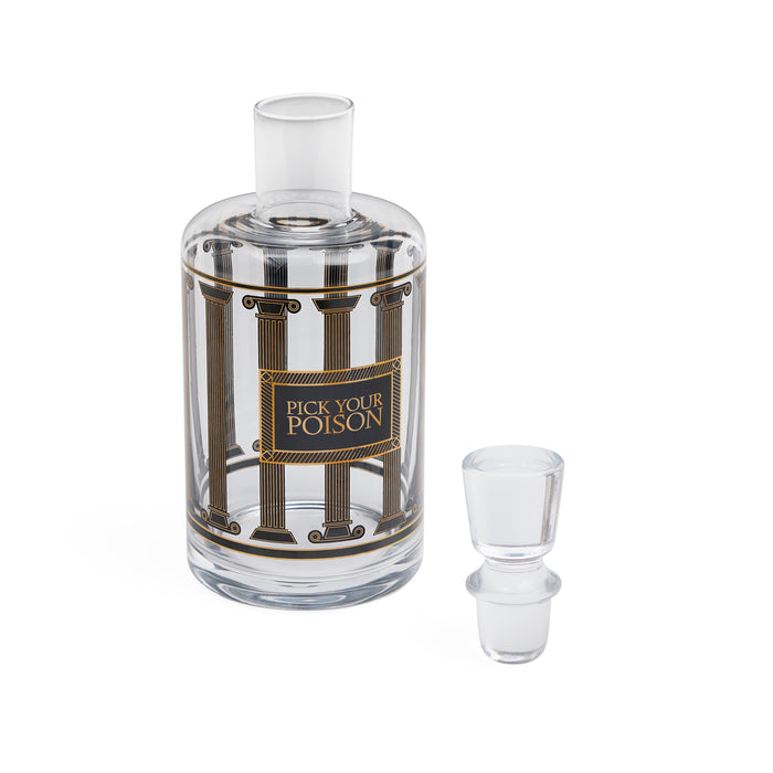 A clear glass decanter bottle with a matching glass stopper, featuring a decorative label with classical columns and the text 'PICK YOUR POISON'.