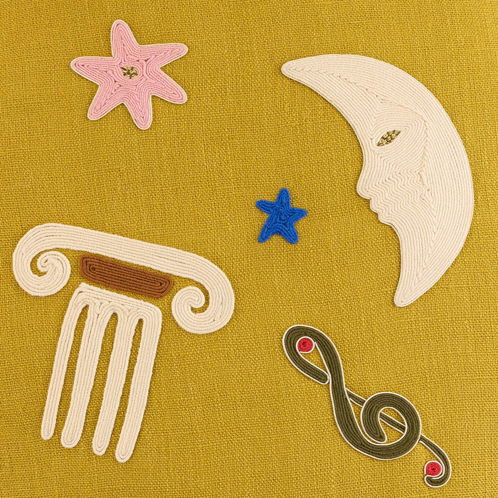 Decorative elements including a star, moon, and other symbols on a yellow background