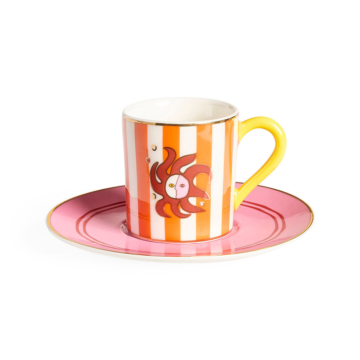 Ceramic cup with saucer featuring a sun design on a white background