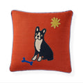 An orange textured throw pillow featuring an embroidered black and white Boston Terrier dog, a blue bone, and a yellow star on a white background.