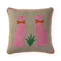 A square beige linen throw pillow with orange piping, featuring an embroidered design of two pink dogs wearing orange collars and a green plant in the center.