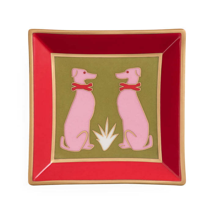 A square decorative plate with a red border, gold trim, and a central olive-green panel featuring two pink dogs wearing red bows, set against a plain white background.