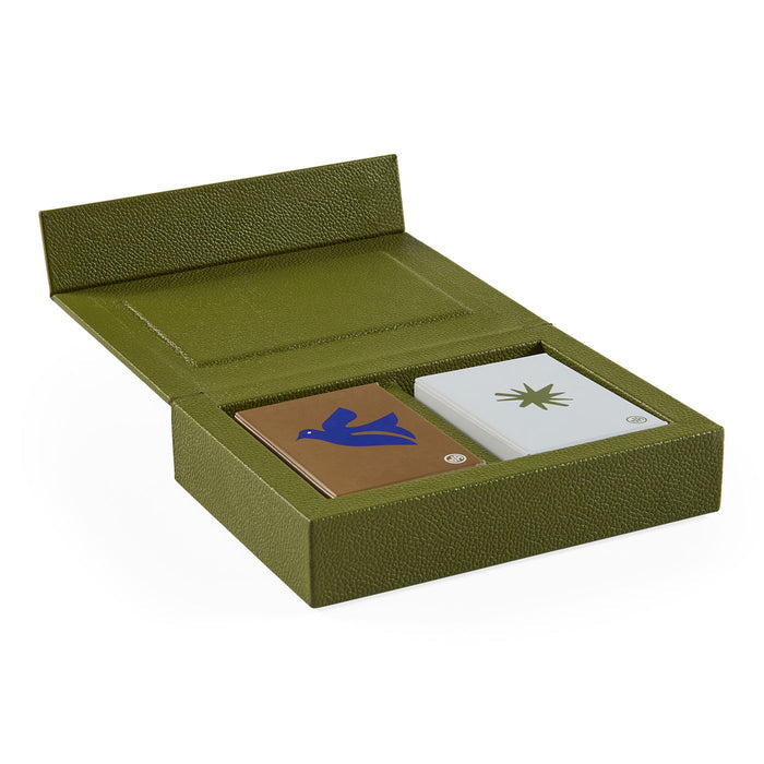 Green leather card holder with two cards inside on a white background