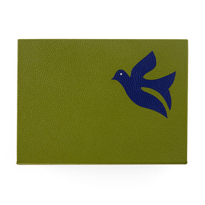 Green leather patch with a blue bird design on a white background