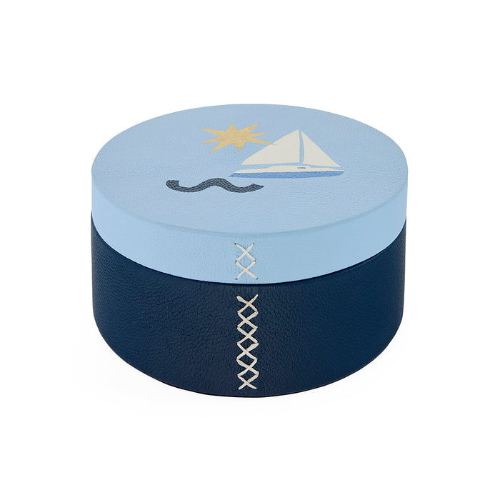 Round decorative box with nautical design elements on a white background