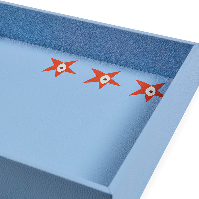 Blue mat with red star designs on a white background