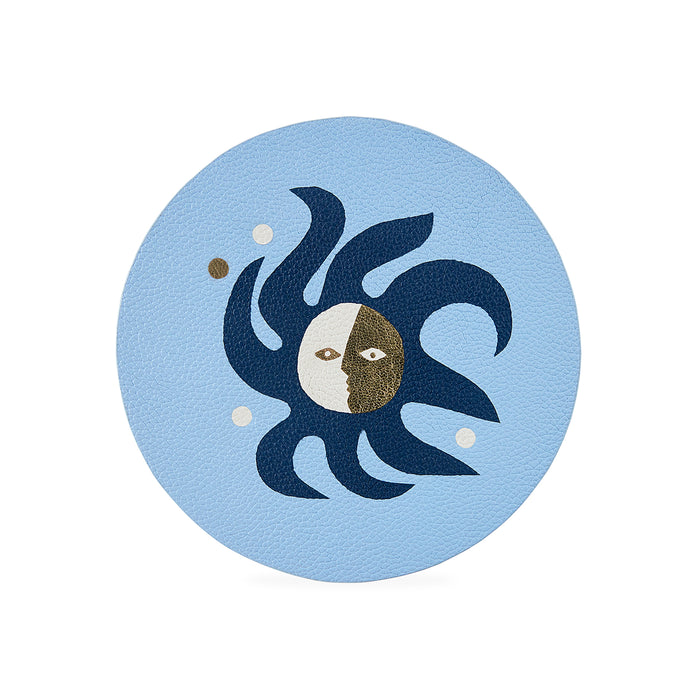 Decorative coaster with sun and moon design on a light blue background