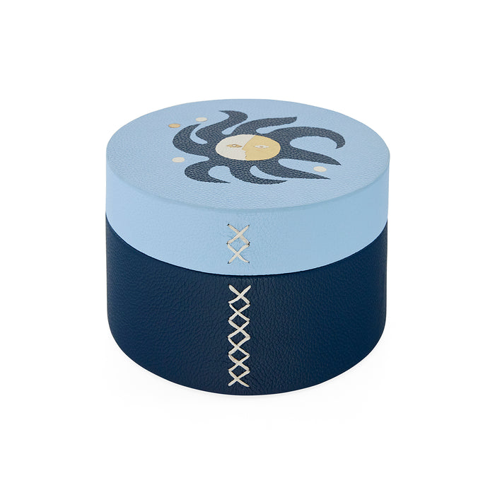 Round blue and navy box with decorative patterns on a white background