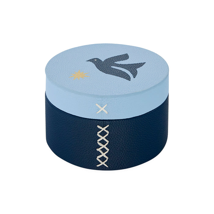 Round decorative box with blue top and navy bottom, featuring a bird and star design.
