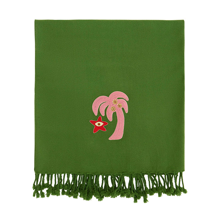 Green blanket with pink palm tree and red star design on a white background