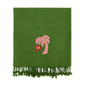 Green blanket with pink palm tree and red star design on a white background