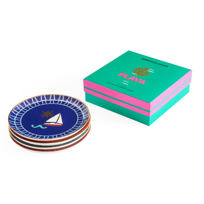 Set of decorative plates with a Jonathan Adler branded box on a white background