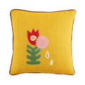 Yellow pillow with floral embroidery on a white background