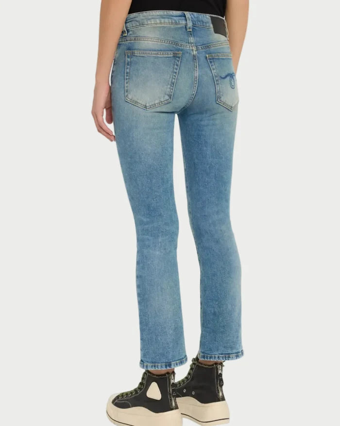 Person wearing blue jeans on a white background