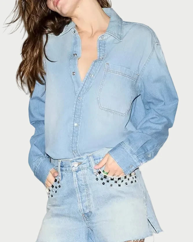 Woman wearing a light blue denim outfit with black boots on a white background