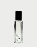 A clear rectangular bottle with a black cap from Riddle Oil exudes an exquisite fragrance. The label on this 8ml "Riddle Oil: Santal" perfume features a minimalist design on the lower part of the bottle, showcasing its sandalwood-infused santal scent against a pale gray background.