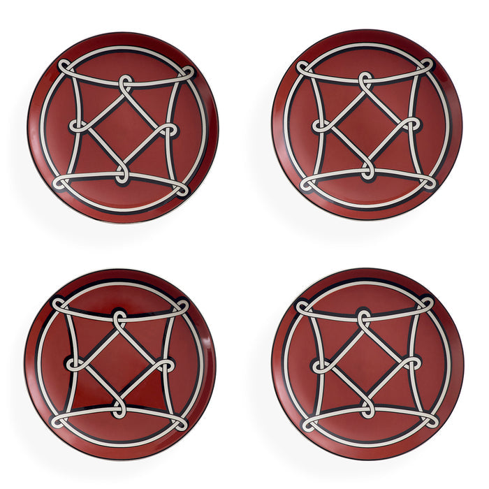 Four round red coasters arranged in a 2x2 grid on a white background, each featuring a white geometric rope-knot design over a circular motif.
