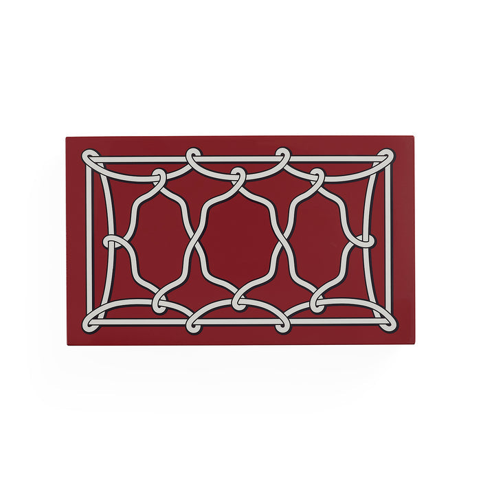A rectangular red mat featuring a white interlocking knot-like geometric pattern, shown on a plain white background.