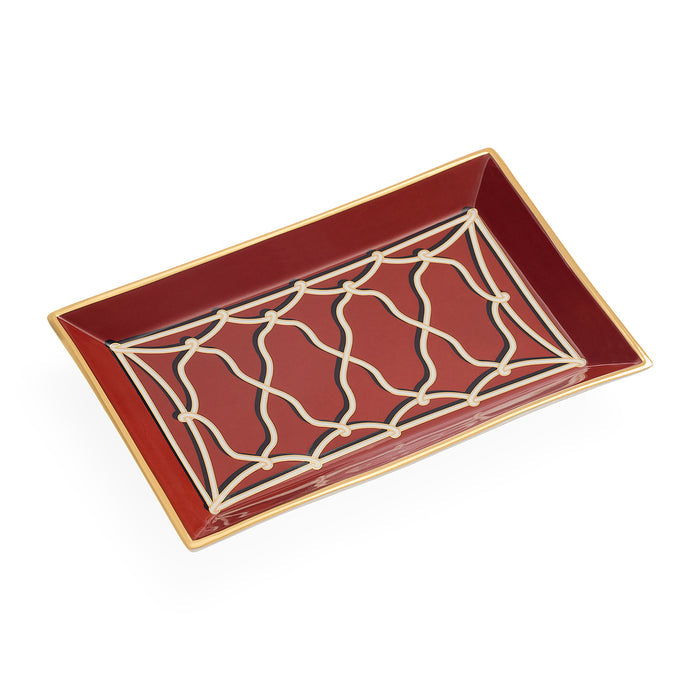 A rectangular ceramic tray with a glossy deep red interior, featuring a cream-colored geometric trellis pattern on the base and a thin gold rim.
