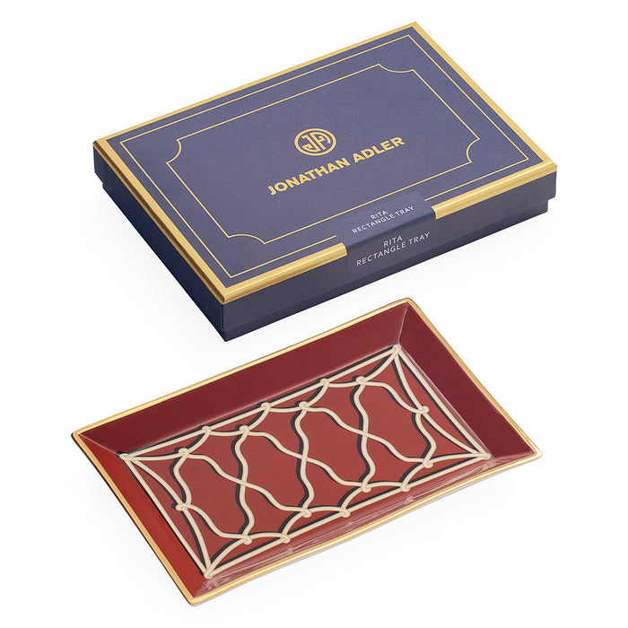 Jonathan Adler Muta Rectangle Tray in deep red with gold and cream geometric detailing, shown alongside its navy blue and gold presentation box.