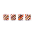 Four clear glass tumblers with a diagonal striped pattern in orange, brown, and white, arranged in a row on a white background.