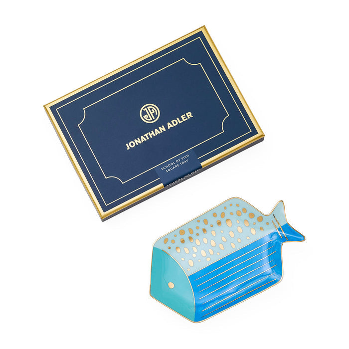 Blue and gold whale-shaped trinket dish with Jonathan Adler packaging on a white background
