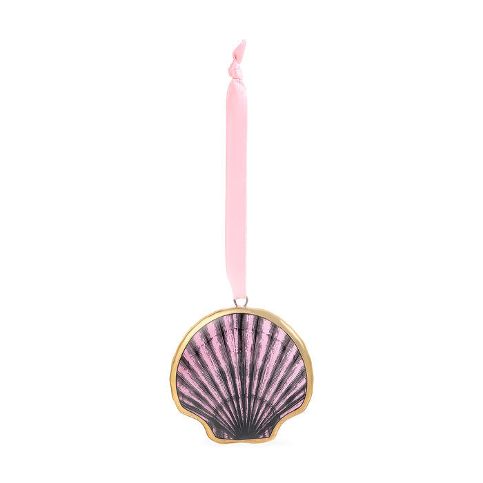 A scallop shell-shaped ornament with a pink and black fan pattern, framed in gold, hanging from a pink ribbon on a white background.
