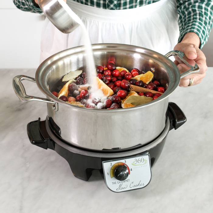 Front view of the Slow Cooker Base showcasing a stainless steel pot filled with cranberries and oranges on the heating base