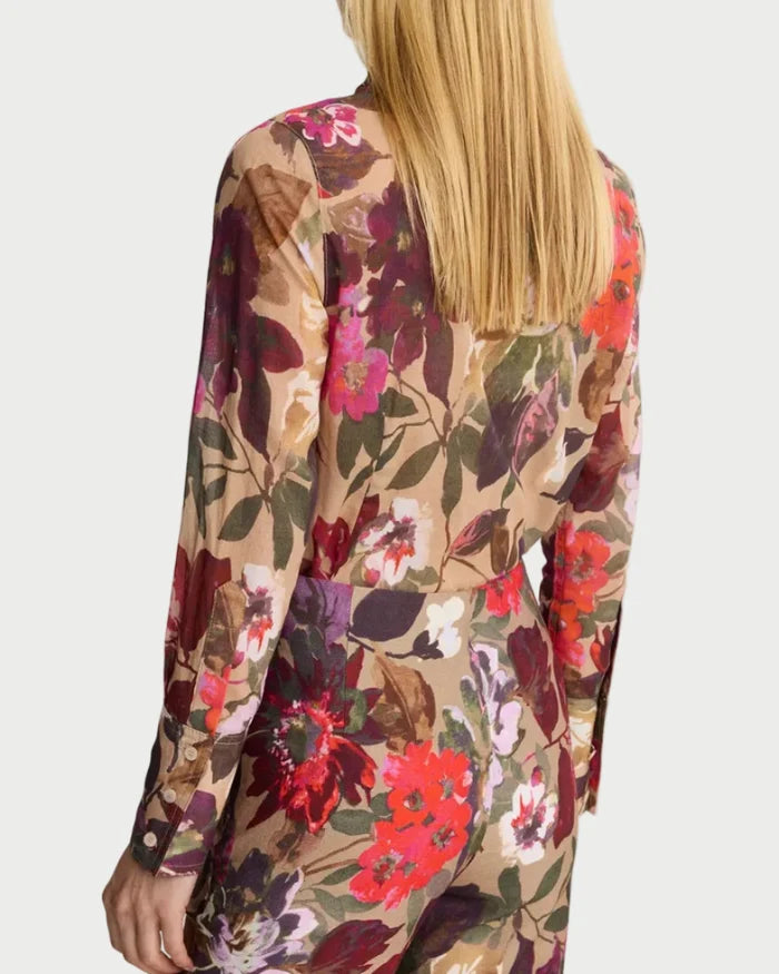 Person wearing a floral patterned outfit on a white background