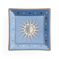 A square ceramic plate with a light blue center and a medium blue border, featuring a central sun and moon design with a cat's face. The plate is decorated with white and black dots along the border and has a gray rim.