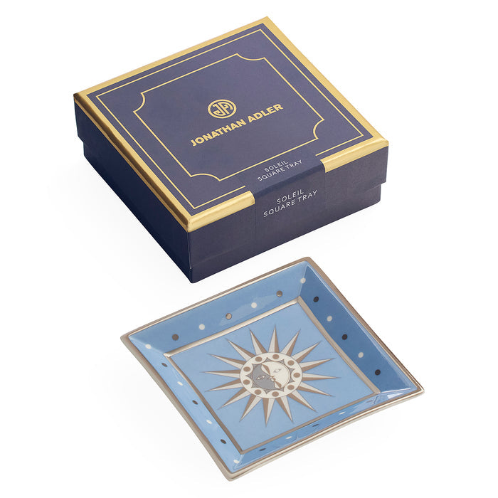 Jonathan Adler Soak Square Tray shown with its navy blue and gold presentation box on a white background.