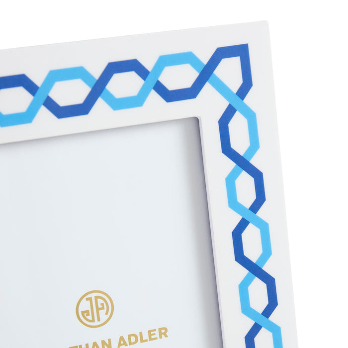 Framed artwork with blue geometric pattern and 'Johan Adler' logo.