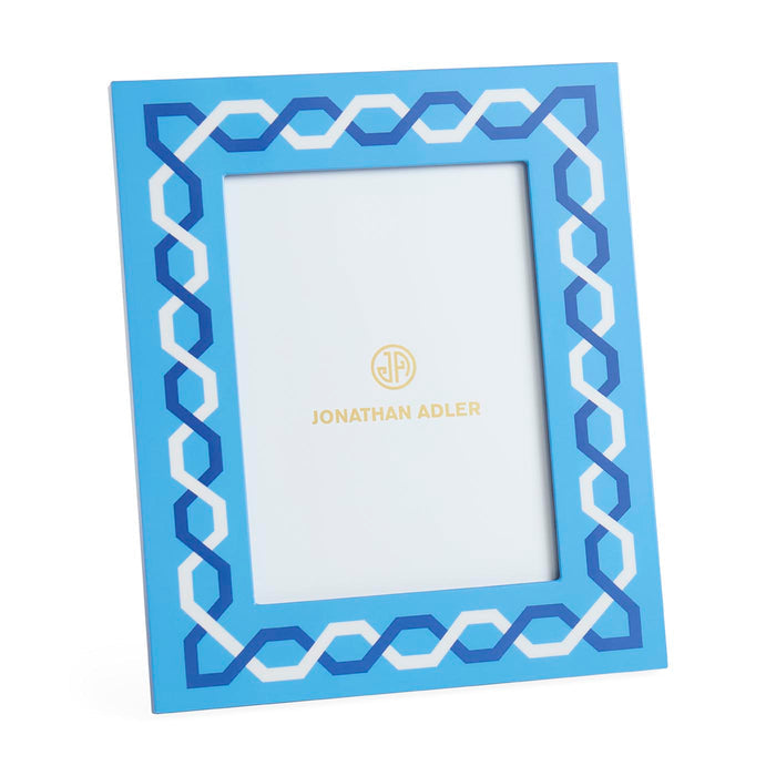 Blue decorative picture frame with white zigzag pattern on a white background