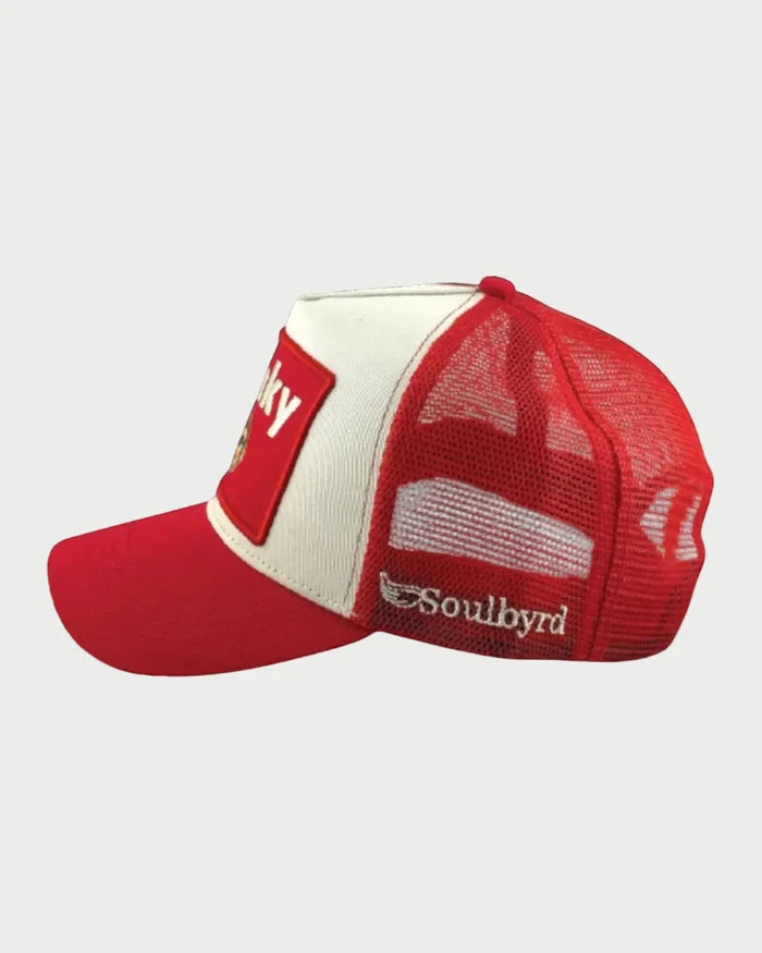 The Soulbyrd Funky Monkey Trucker Hat features a solid red bill, mesh back, side "Soulbyrd" patch, adjustable snapback, and a front panel with a red rectangle and bold white text.
