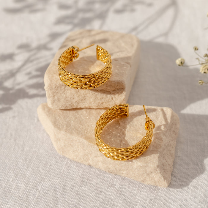 flat lay of gold hoop earrings with a beaded texture