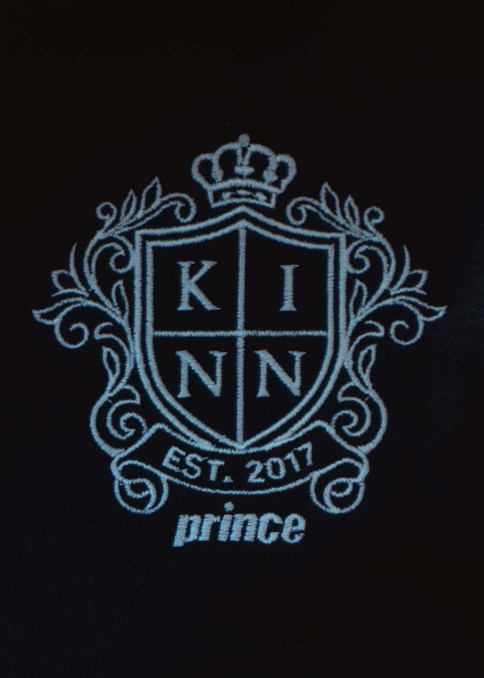 close up of the emblem embroidery on the  Kinn x Prince The Club Quarter-Zip Sweatshirt