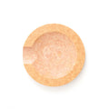 Top view of round natural wood utensil rest showing carved spoon notch and smooth finished surface on white background